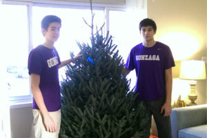 Duncan MacBride and Sam Gonson set up a Christmas tree
