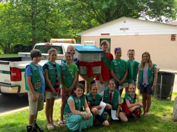 Girl Scout Troop 3661 in front of their Little Free Library in Bluemont Park, Photo courtesy of Girl Scout Troop 3661, photo courtesy of Photo courtesy of Girl Scout Troop 3661.