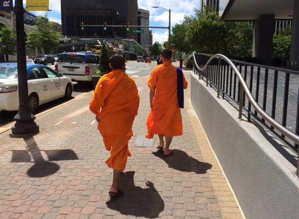 Two men in religious garb walking through Rosslyn