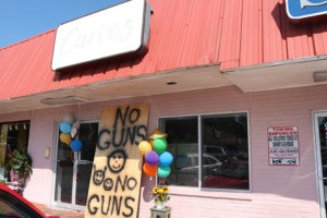 "No Guns" sign outside of former Curves studio.
