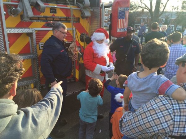 Children and parents gather around Santa and his fire truck in Fairlington