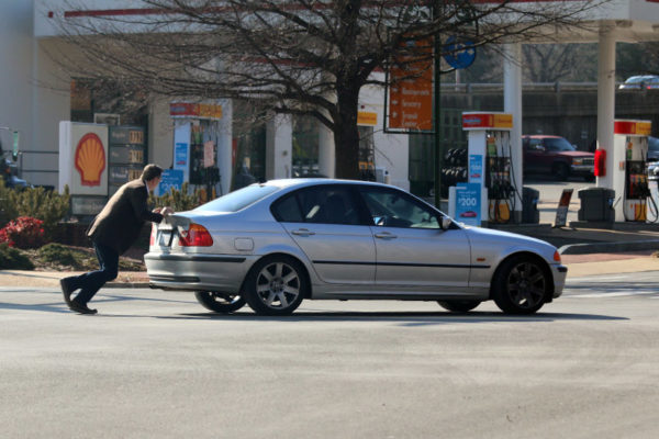 Man pushing a disabled BMW to the Shell station in Shirlington 3/7/16