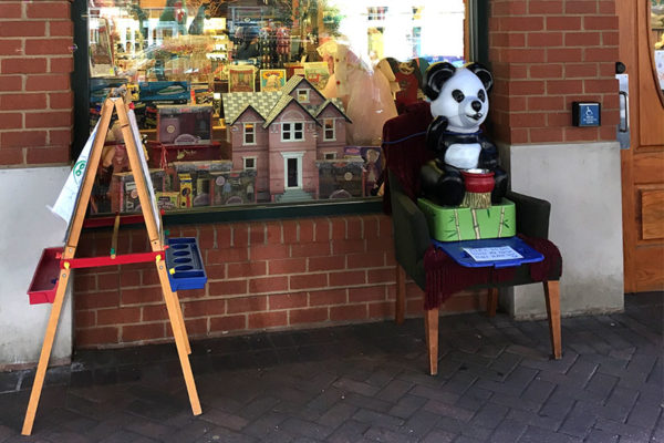 Mr. Panda fills in for the stuffed bear outside of Kinder Haus Toys in Clarendon (photo courtesy Eric LeKuch)